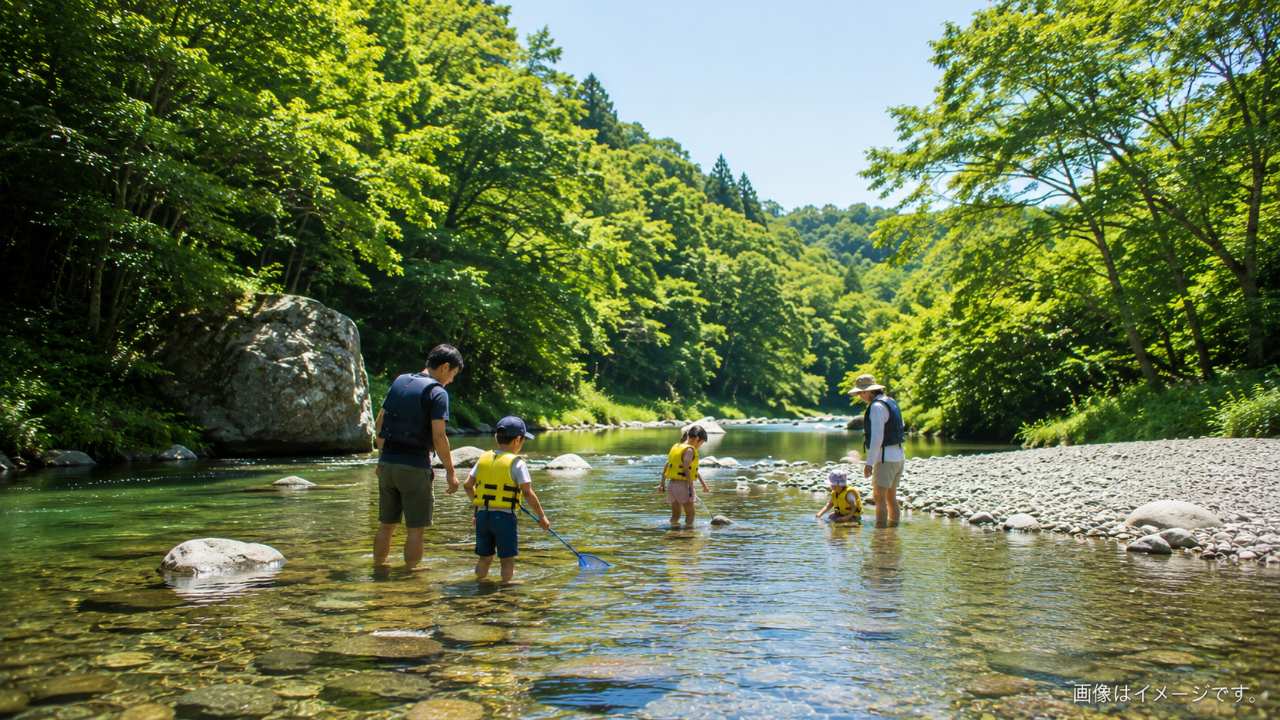 巾着田西側の高麗川で指定された水遊び区域を確認する家族